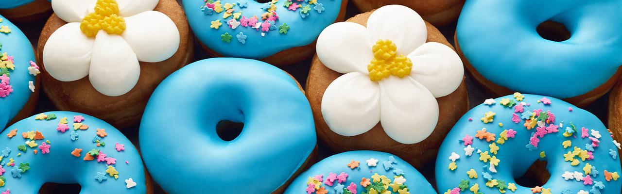 A range of spring-themed donuts with blue icing